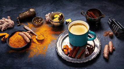 Sticker - Healthy turmeric golden milk on dark background.