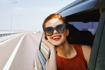 Wall Mural - pretty woman in sunglasses rides in a travel car