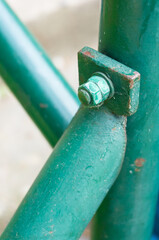 Canvas Print - Vertical shot of bolt in a green pole