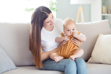 Poster - Photo of positive nice glad mother lady embrace cute son sit comfy couch wear white t-shirt home indoors