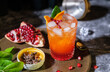© weedezign - oragne juice mixed with pomegranate cocktail beverage drink on table