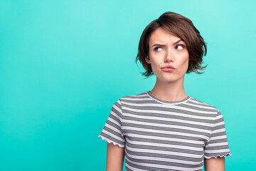 Sticker - Photo of young attractive girl serious brainstorming think minded look empty space isolated over teal color background