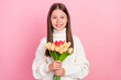 © deagreez - Portrait of attractive cheerful cute girl holding in hands tulips mom day isolated over pink pastel color background