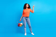 Full body photo of young afro woman happy smile point finger empty space advert suggest mall shop isolated over blue color background