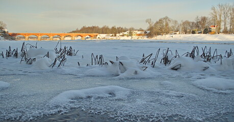 Wall Mural - Long brick bridge over Venta river in winter day, Kuldiga, Latvia.