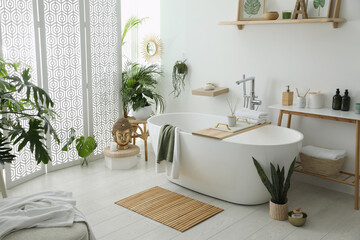 Canvas Print - Stylish bathroom interior with modern tub, houseplants and beautiful decor. Home design