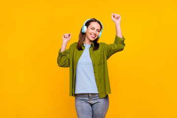 Canvas Print - Photo of pretty charming young woman dressed green shirt headphones dancing smiling isolated yellow color background