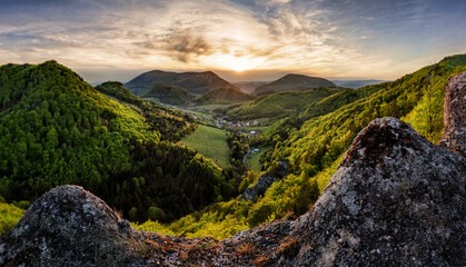 Wall Mural - rocks and forest landscape at dramatic sunset, spring time