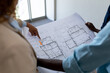 © Wavebreak Media - Female architect pointing at blueprint during meeting with colleagues in office