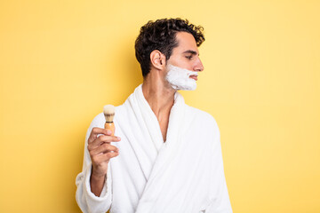 Wall Mural - young handsome man on profile view thinking, imagining or daydreaming. shaving and foam concept