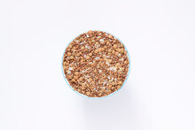 A Mixture Of Dry Cereals In A Round Cup Top View White Background