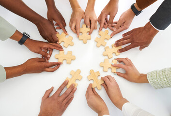 concept background with diverse multiracial group of young people joining parts of jigsaw puzzle on 