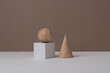 Wood geometric blocks on a brown white background- still life painting concept