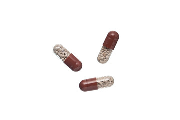 Wall Mural - Brown and transparent plastic capsule pills,  Isolated on a white background.
