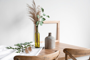 Canvas Print - Beautiful dried flower bouquet in bottle on wooden table