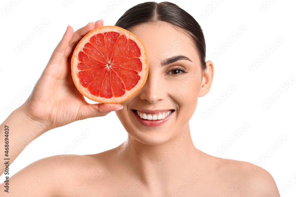 Beautiful smiling woman with grapefruit on white background