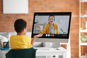 Sticker - Little African-American boy studying online at home