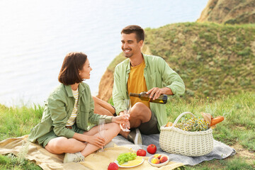 Canvas Print - Happy young couple having romantic picnic in mountains