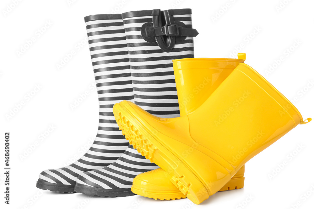 Two pairs of rubber boots on white background