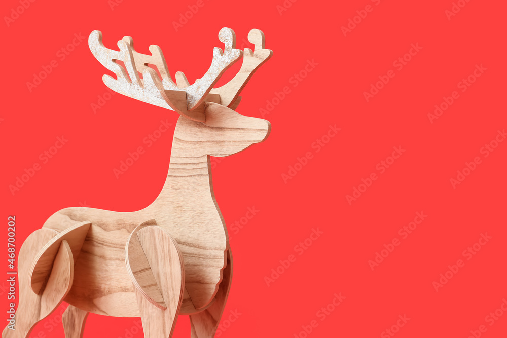 Wooden reindeer on red background