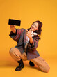 © Blue Jean Images - Studio shot of fashionable young woman holding a smart phone