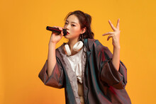 Studio shot of fashionable young woman singing