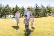 © Blue Jean Images - Happy family playing football in park