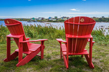 Canada Parks Red Adirondack Chairs In Aguanish, A Small Town Located In Cote Nord Region Of Quebec (Canada)