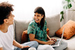 © (JLco) Julia Amaral - Female couple laughing together at home