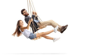 Wall Mural - Side shot of a father and daughter swinging on wooden swings