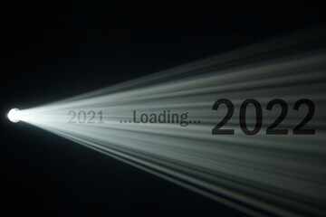 Wall Mural - light beam from spotlight or projector texture and black background with 2021 loading 2022 word - ha
