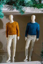 Mannequins Of Men's Clothing In A Shop Window. Sale Of Knitted Sweaters.
