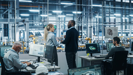 Fototapete - Car Factory Office: Team of Automotive Engineers Working, Talk, Use Tablet Computers to Design Advanced 3D Models for High-Tech Engines. Automated Robot Arm Assembly Line Manufacturing Vehicles
