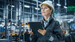 © Gorodenkoff - Car Factory Office: Portrait of Female Chief Engineer Wearing Hard Hat Monitoring Production Conveyor with Tablet Computer. Automated Robot Arm Assembly Line Manufacturing High-Tech Electric Vehicles