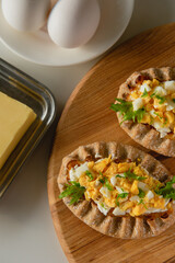 Wall Mural - Karelian rice pies, eggs and butter on the table.