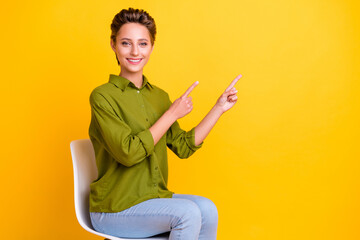 Canvas Print - Photo of promoter lady sit chair direct finger empty space wear green shirt isolated yellow color background