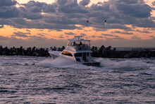 Motor Boats Heading Out Of Manasquan Inlet At Sunrise To Go Fishing