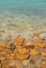 A Picture Of The Dead Sea In Jordan, Which Is Characterized By Its Salty Mineral Water