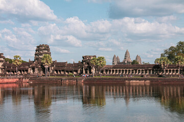 Poster - Ancient famous Buddhist temple of Angkor Wat in Cambodia under a blue cloudy sky