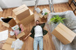 © Syda Productions - moving, people and real estate concept - happy smiling man with boxes lying on floor at new home