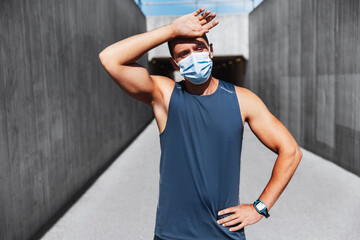 Canvas Print - fitness, sport and health concept - tired young man in medical mask doing sports outdoors