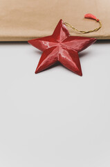 Poster - red wooden star Christmas decoration on a white and brown paper background