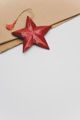 Poster - red wooden star Christmas decoration on a white and brown paper background