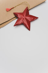 Poster - red wooden star Christmas decoration on a white and brown paper background