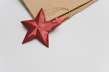 Poster - red wooden star Christmas decoration on a white and brown paper background