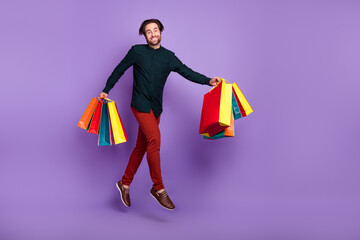 Sticker - Photo of sweet charming young man wear smart casual outfit smiling holding hoppers jumping high empty space isolated purple color background