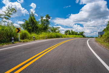 Sticker - country road rolls over hills on a sunny day