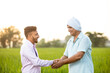 © Photographielove - Indian farmer with Banking person shaking hand after Deal done