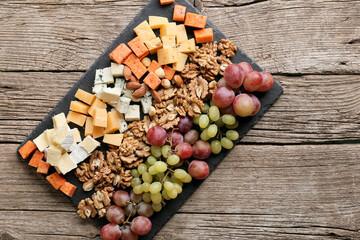 Wall Mural - Cheese plate with variety of appetizers on table