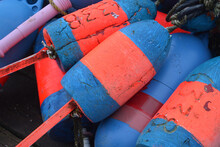 Red And Blue Well Used Lobster Floats On A Dock In Maine